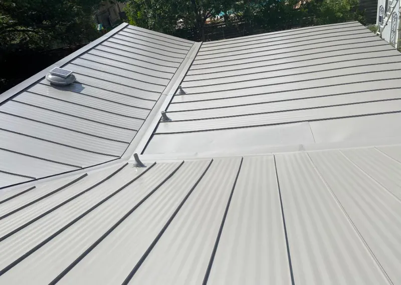 Solar attic fan installed on a metal roof for Roof Ventilation in Northchase